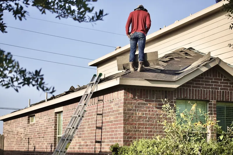 Professional roofer working on a residential roof in Liberty Lakes